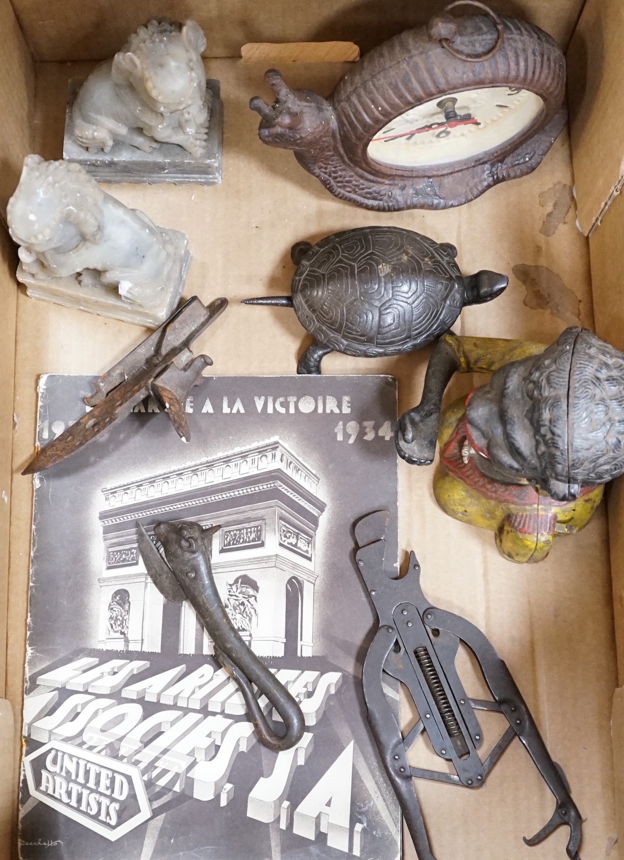 A metal figural money box, a pair of hardstone temple dogs, a novelty snail clock, metal tools and a United Artists 1930 illustrated magazine